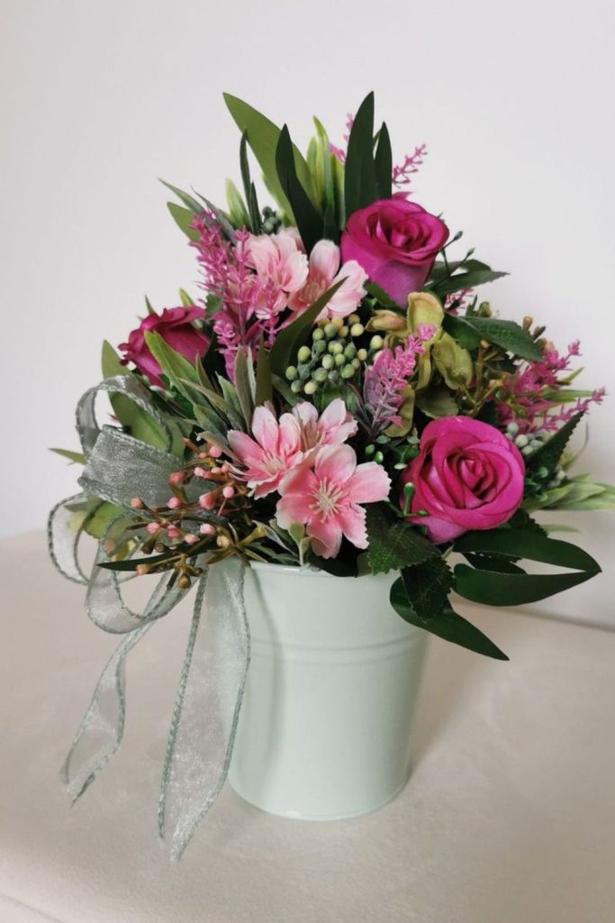 Green ferns with pink blossoms
