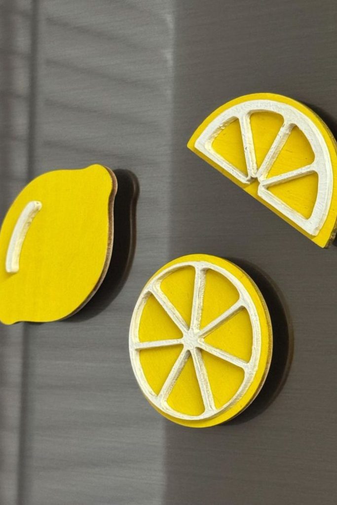 Fridge magnets forming playful citrus kitchen decor display