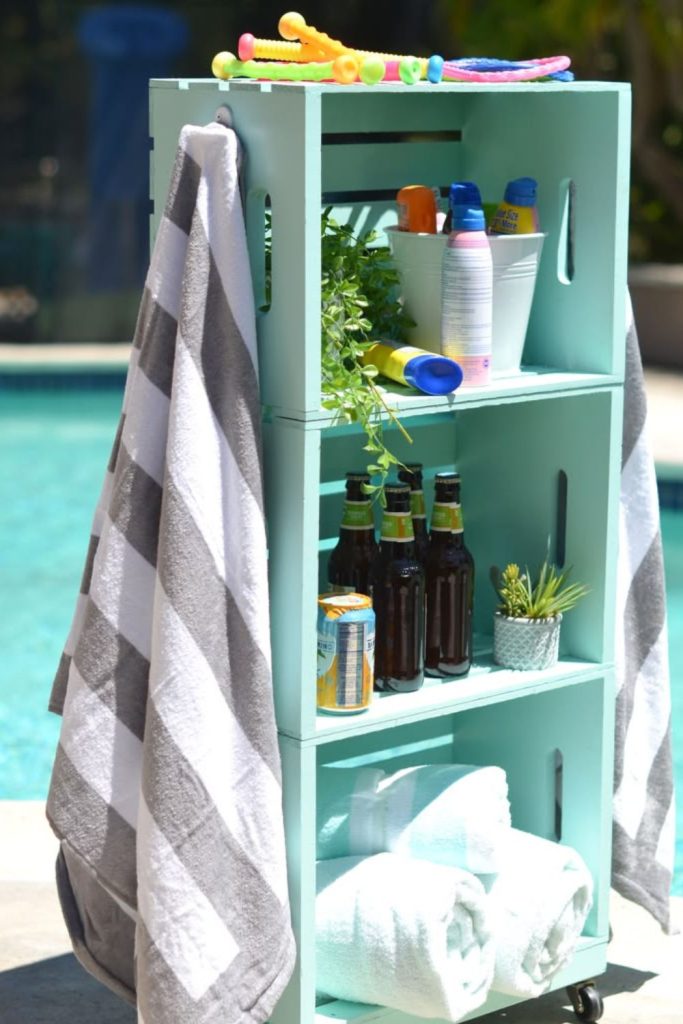 Driftwood crates storing colorful pool floats
