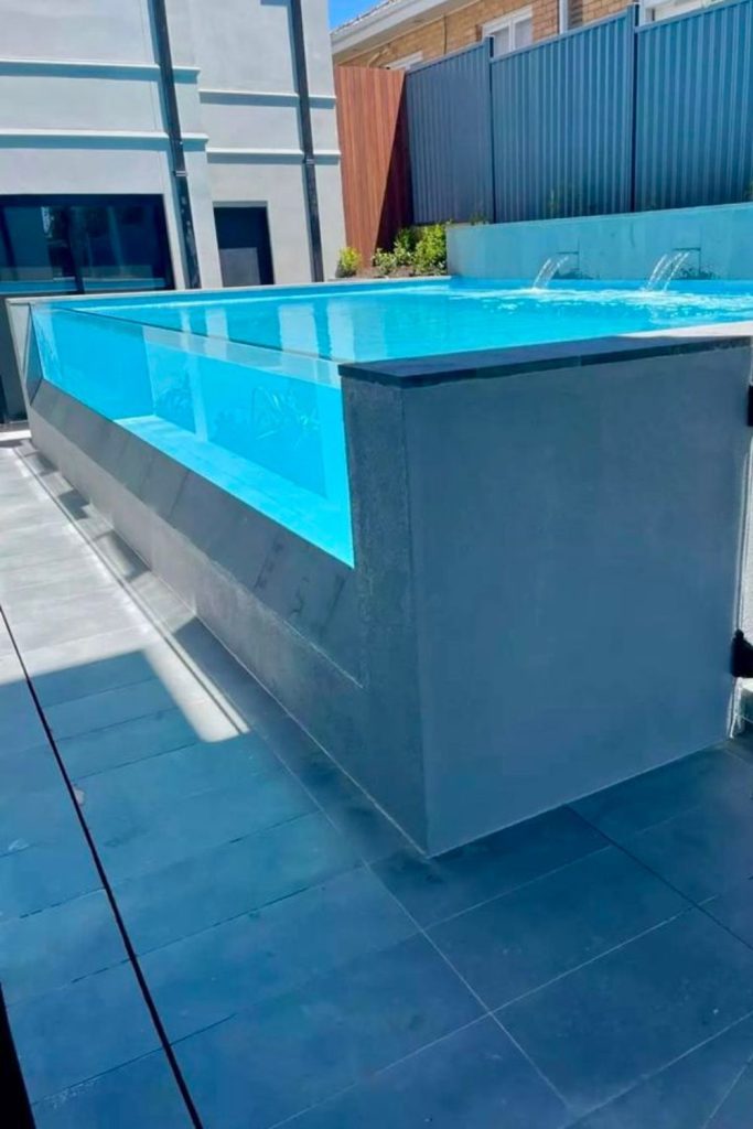 Glass wall pool, transparent modern visual water display.