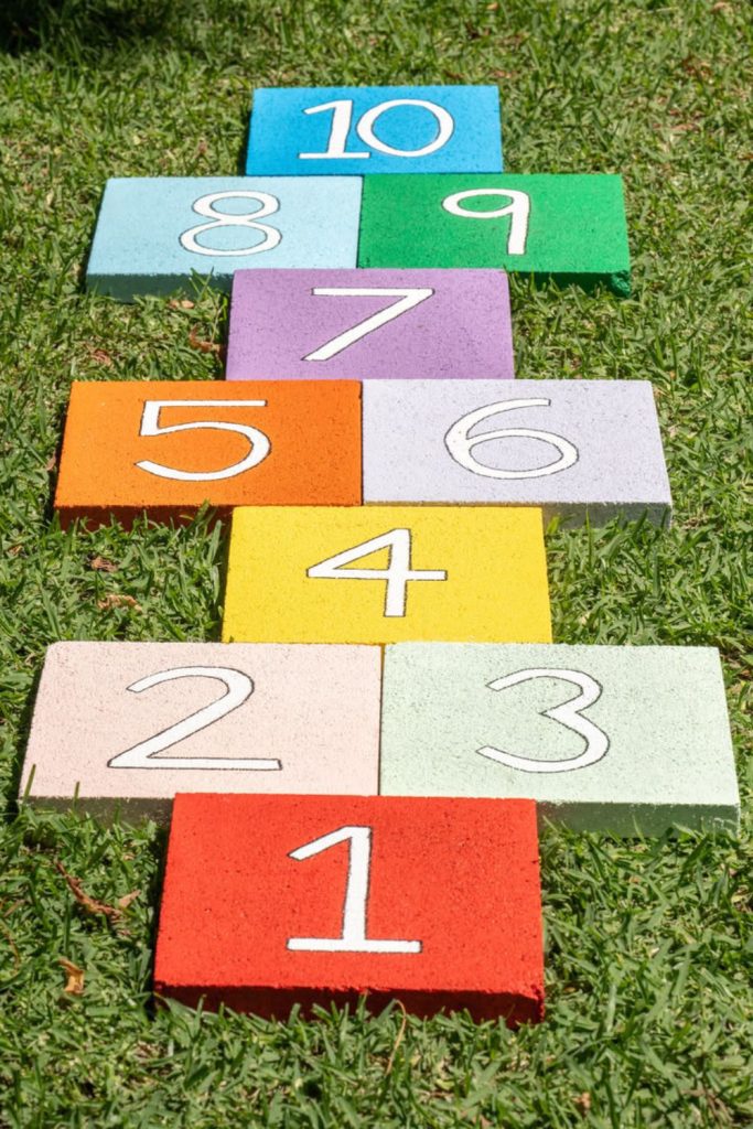 Colorful hopscotch chalk game outdoor setup.