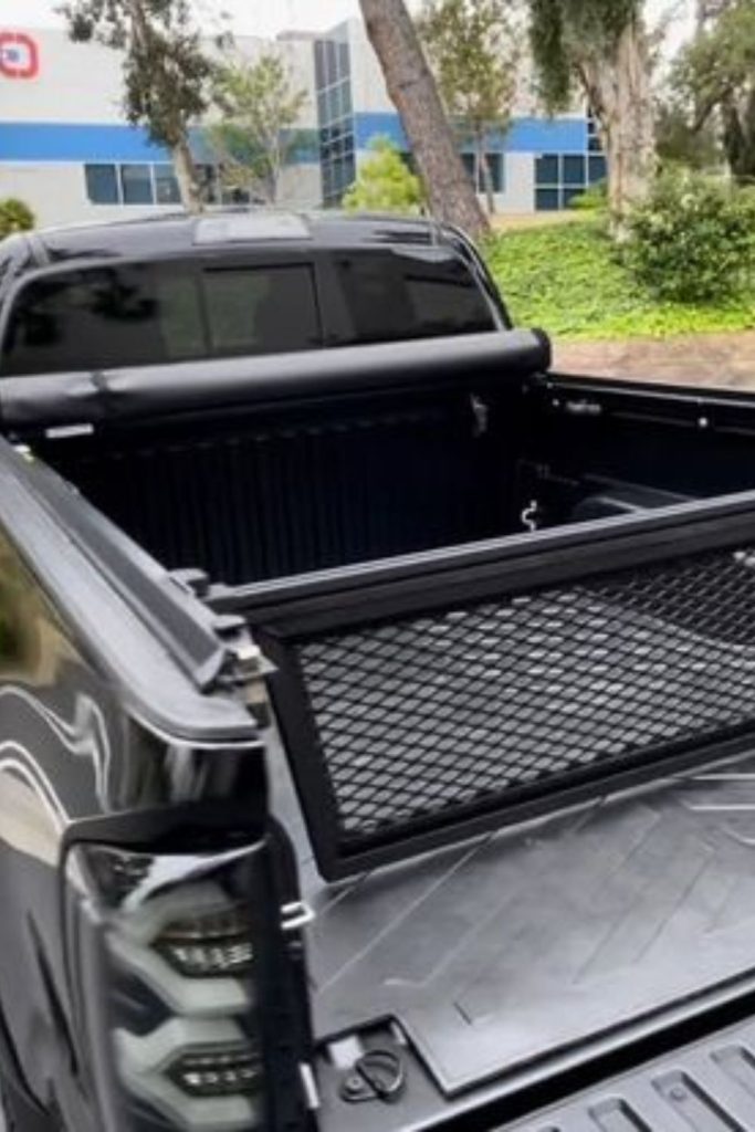 Retractable divider curtain truck bed storage