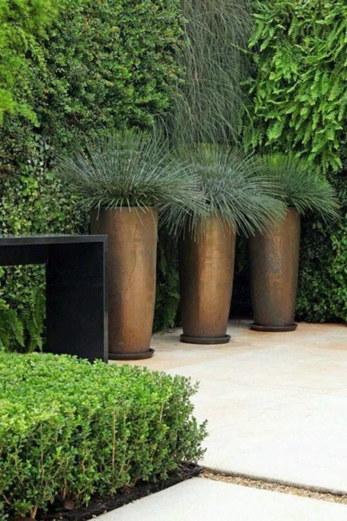 Tall rusted steel vertical planter sculpture