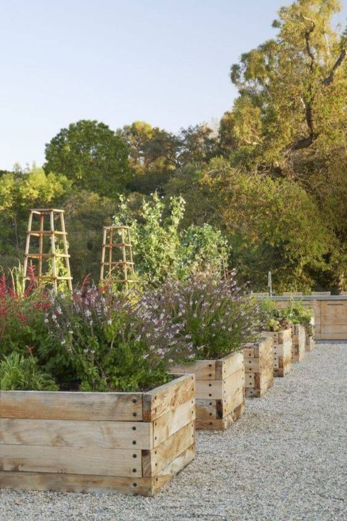 Farmhouse backyard with wooden planters.