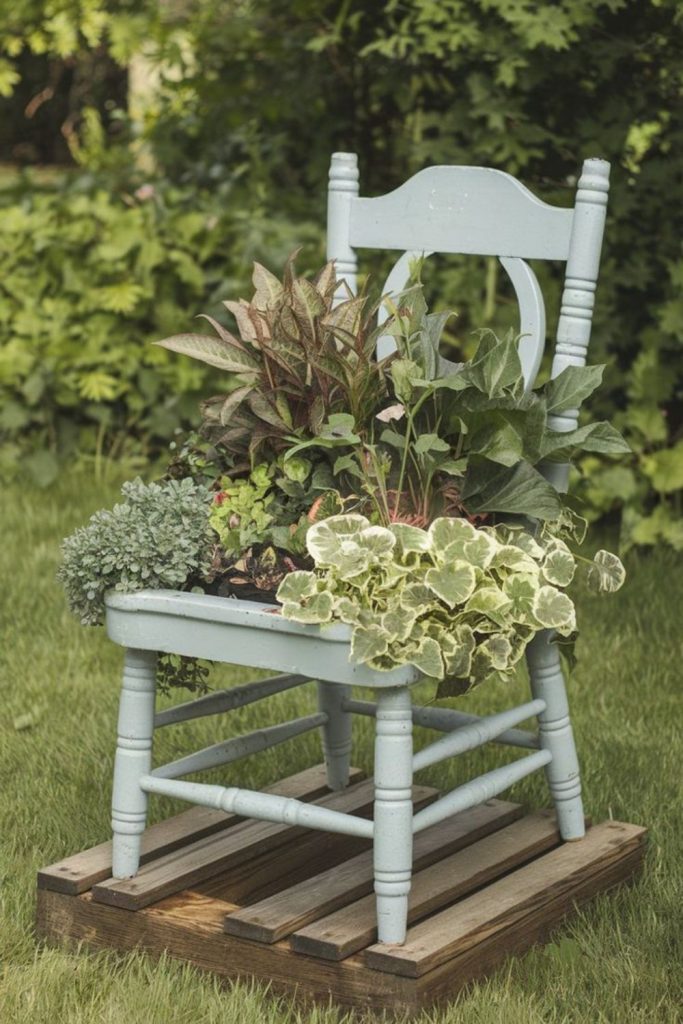 Old chair repurposed plant stand display