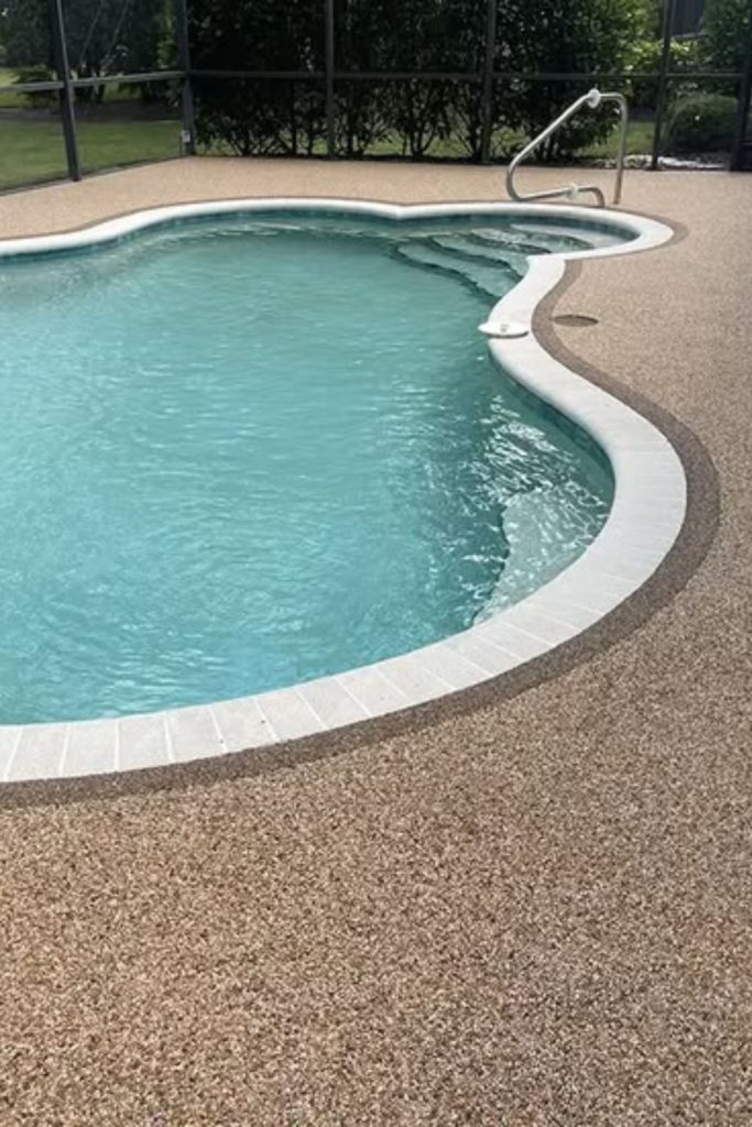 Smooth pebble resin poolside deck surface