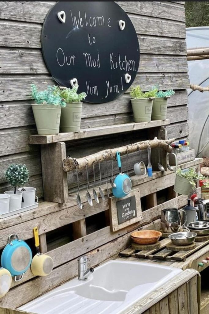 Rain barrel outdoor mud kitchen setup.
