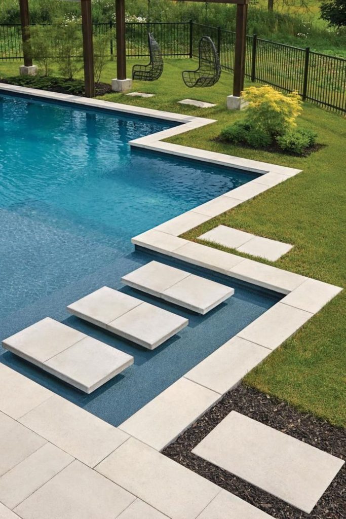 Layered sandstone steps surrounding backyard pool