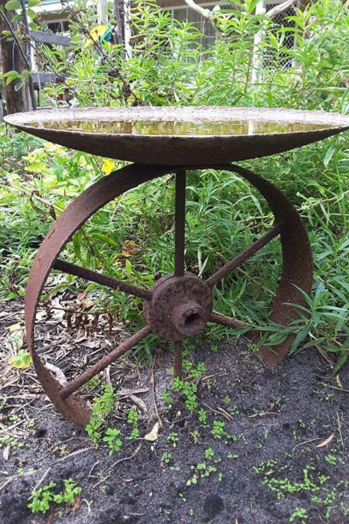 Wagon wheel rustic bee bath.