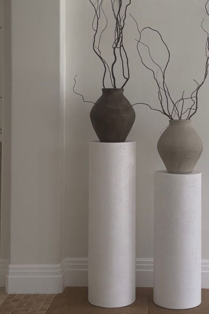 Minimalist concrete pedestal plant stand.