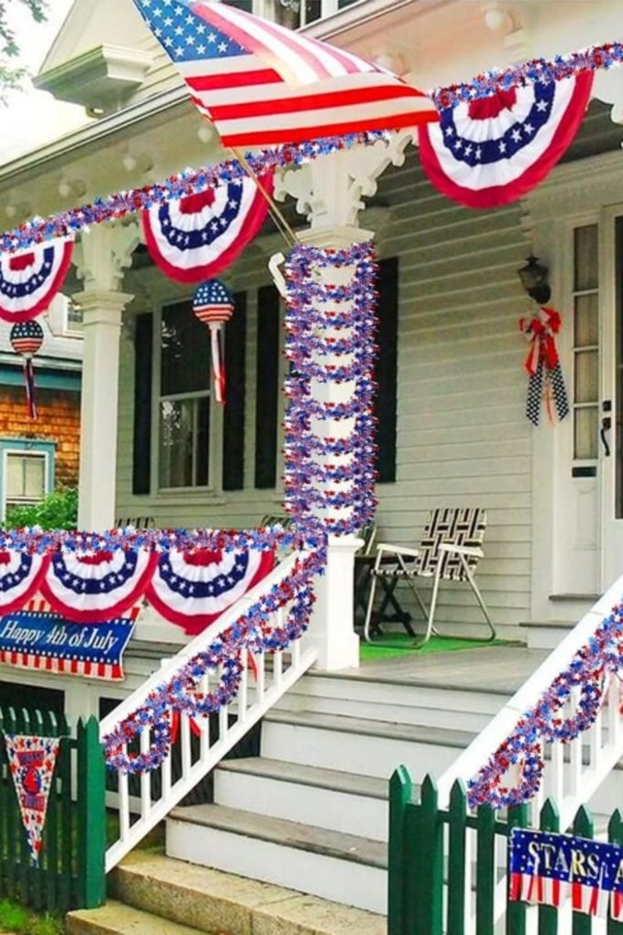 Flowing flag garlands decorating porch stairs