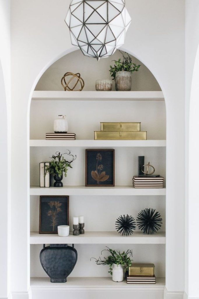 Modern arch decor shelf arrangement.