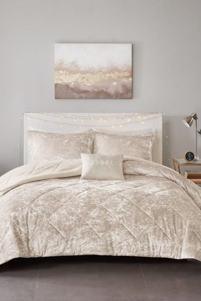 Champagne satin bedding with crystal accents.