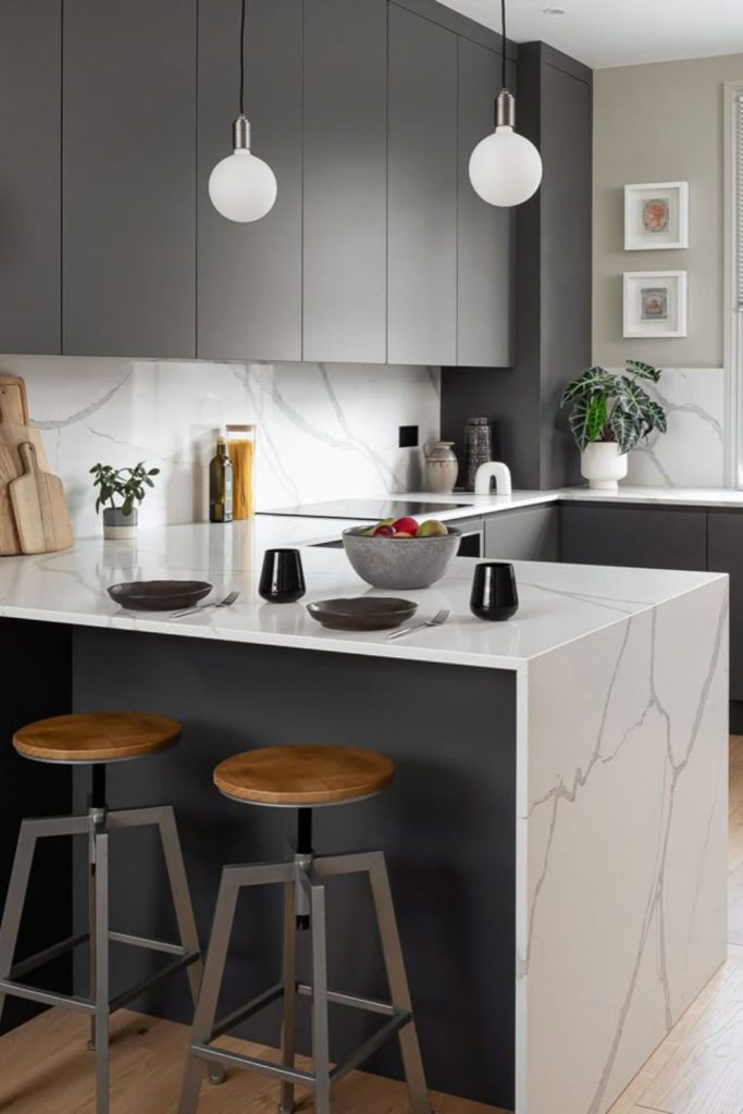 Double waterfall marble kitchen island design.