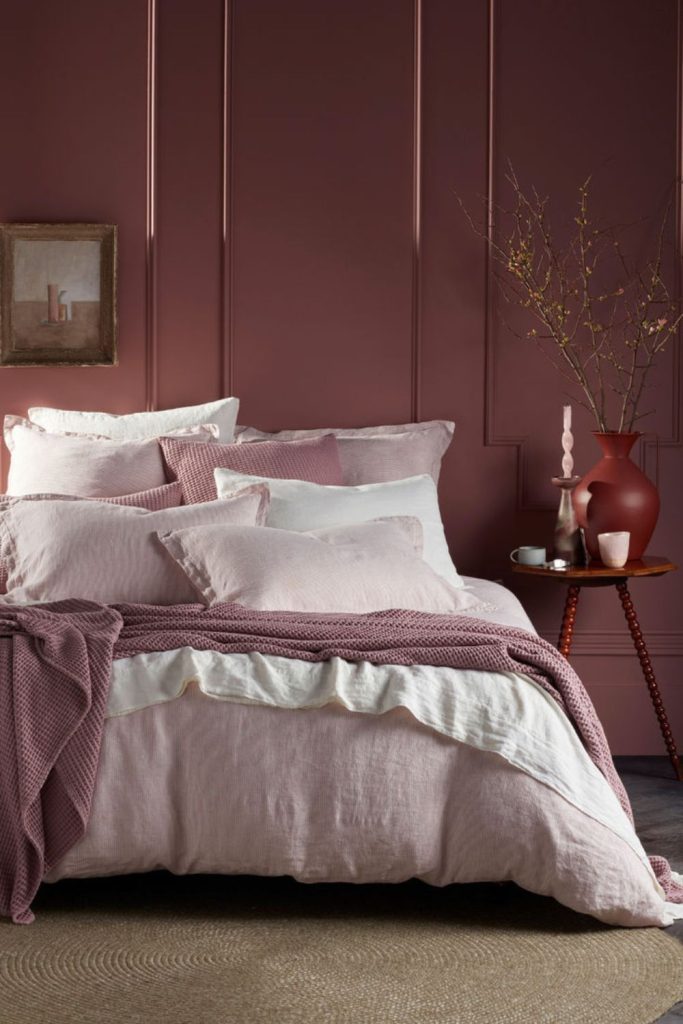 Dusty rose bedding with linen throw.