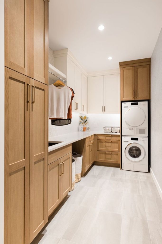 Natural oak laundry room storage cabinets.