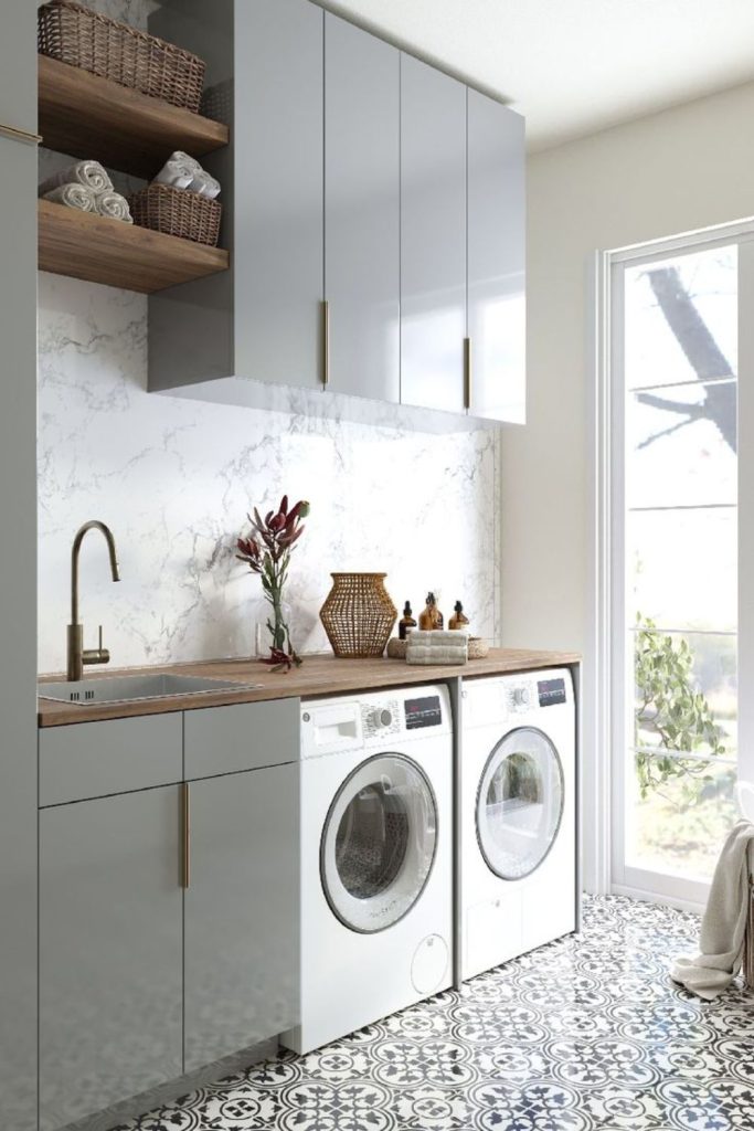 Two-tone modern laundry room cabinets.