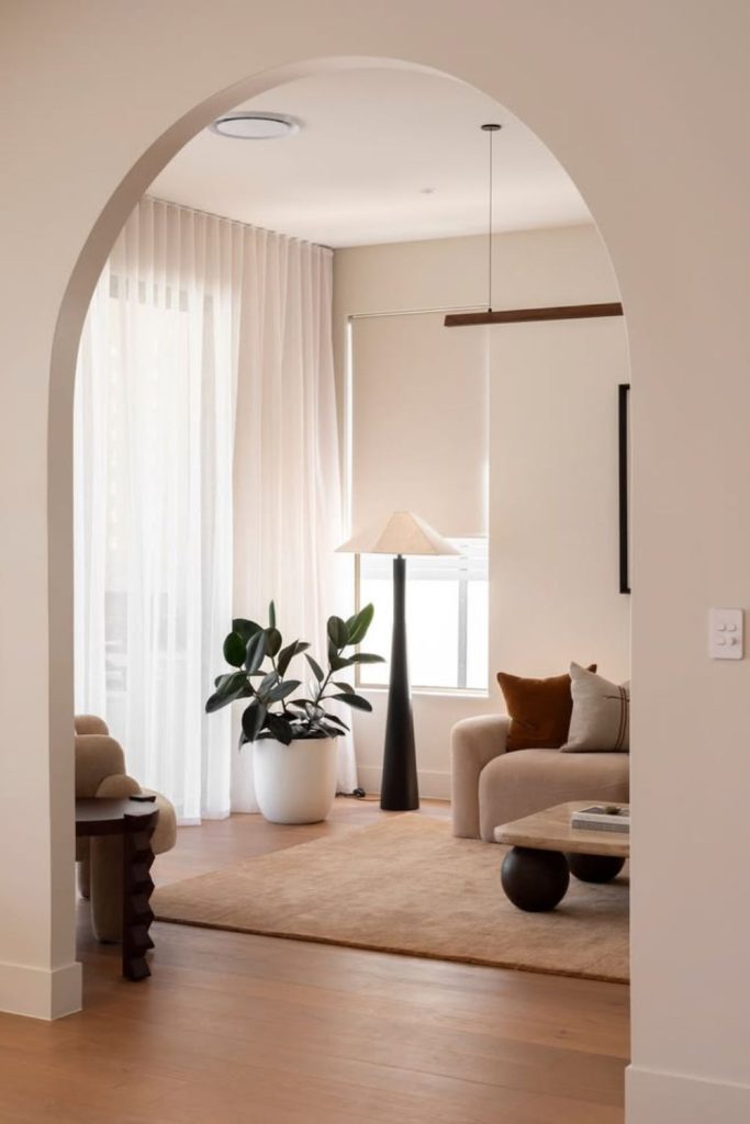 Arched transition broken plan lounge design.