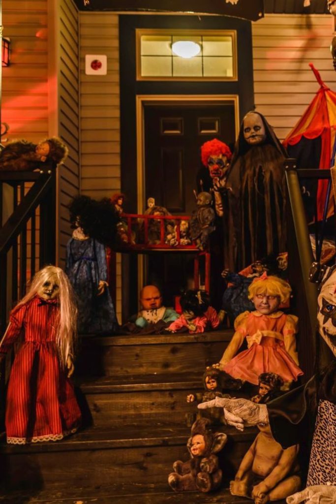 Creepy vintage dolls decorating haunted porch.
