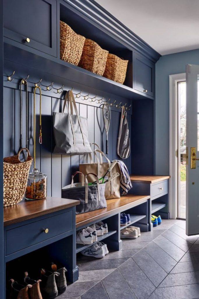 Dramatic navy boot room with tiles.