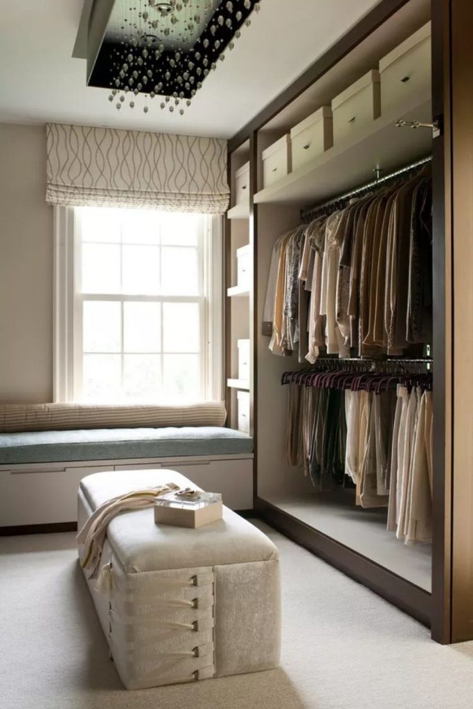 Walk-in dressing room with seating.