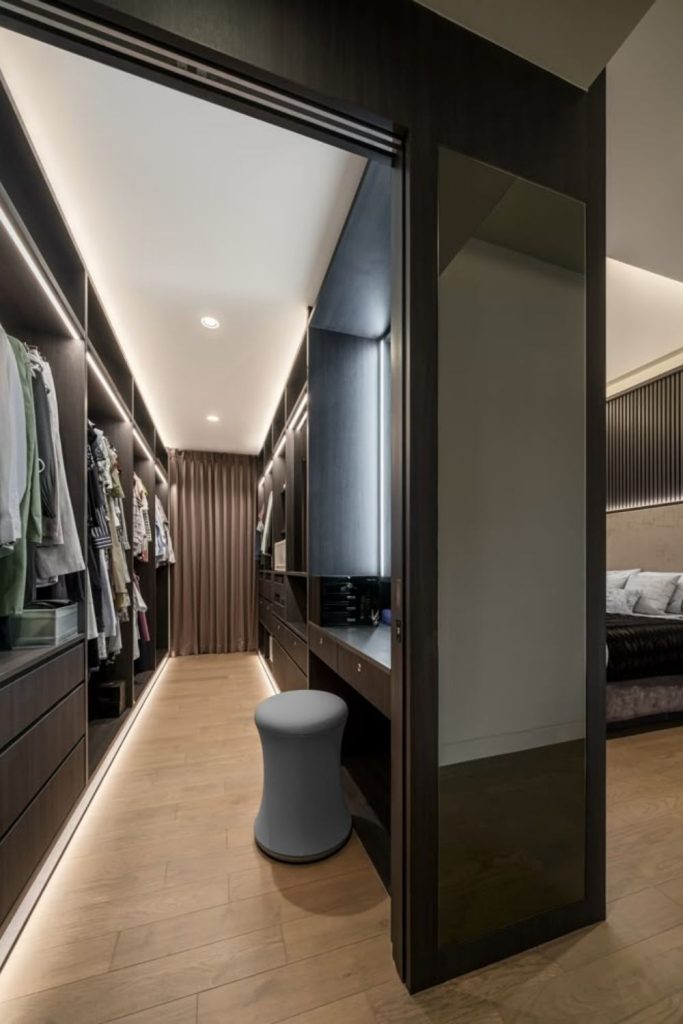 Hidden dressing sanctuary with sleek cabinetry.