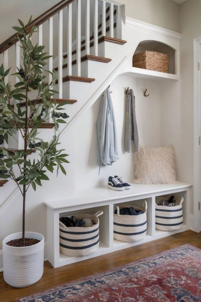 Compact mudroom storage beneath stairs.