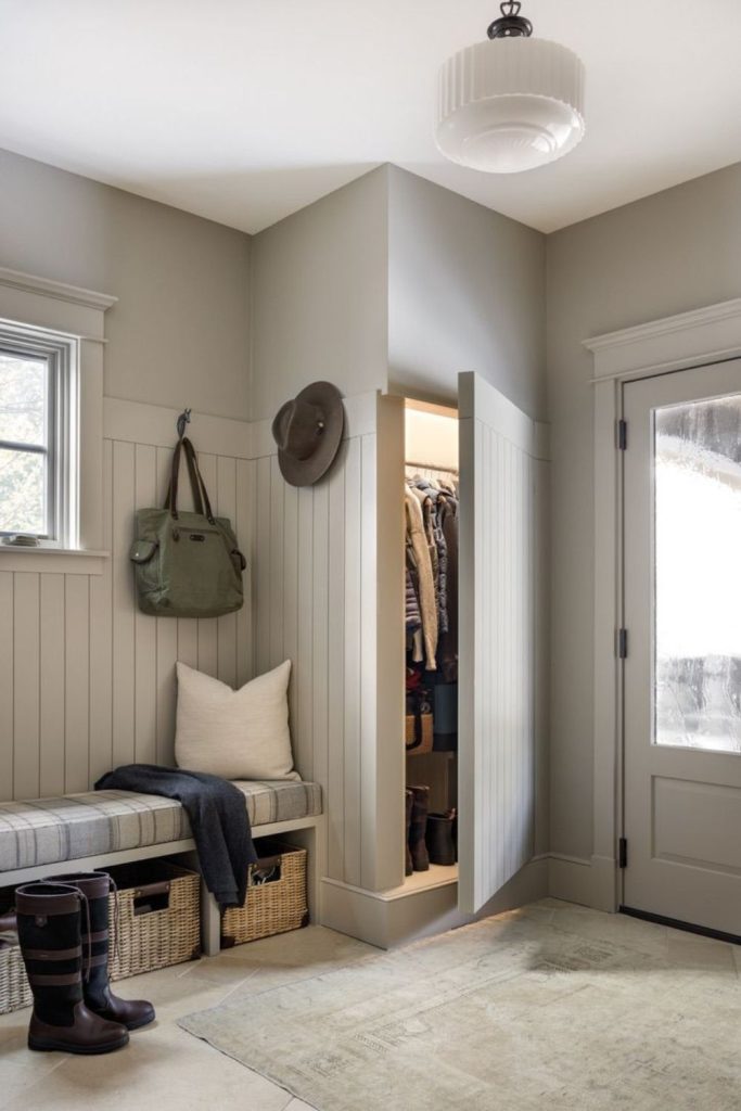 Hidden storage mudroom entryway design