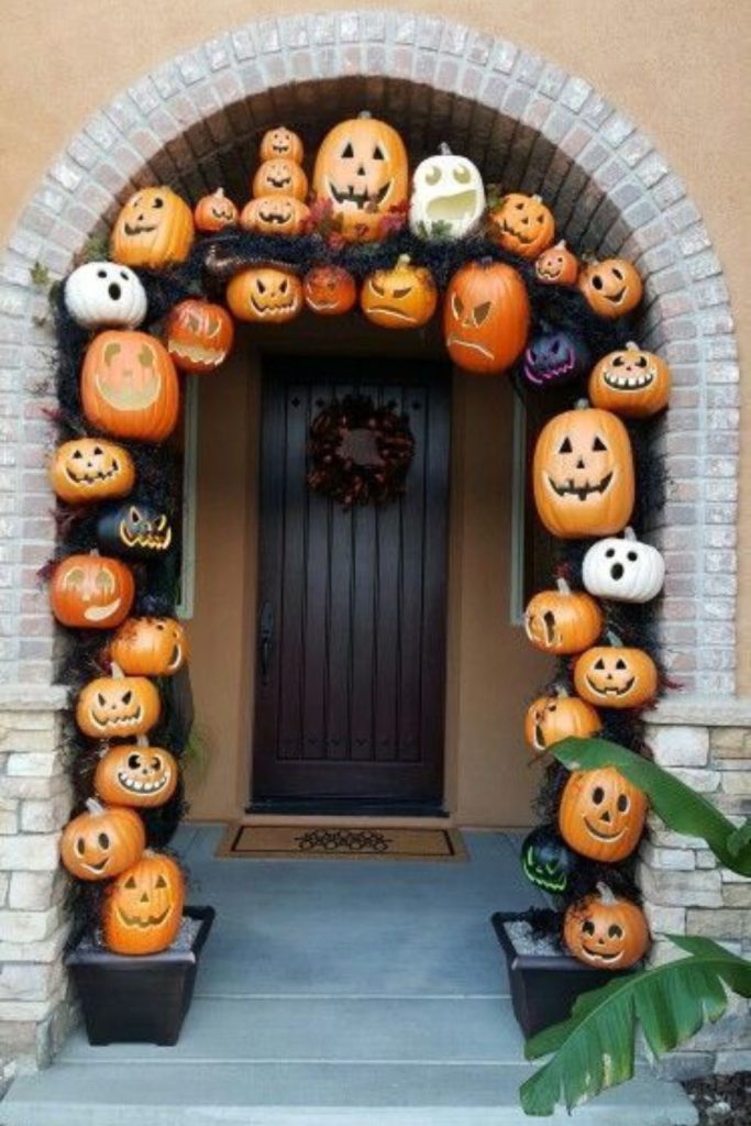 Pumpkin archway decorating spooky front porch.