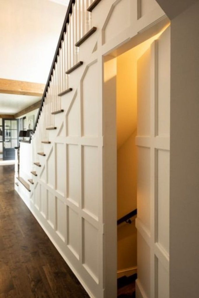 Secret door storage beneath stairs.