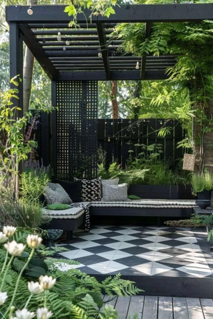 Contemporary black courtyard with tropical foliage.
