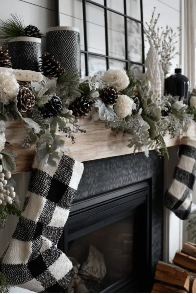 Elegant monochrome Christmas mantel with candles.