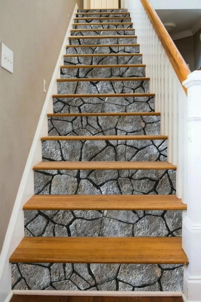 Natural stone staircase with wooden handrail.