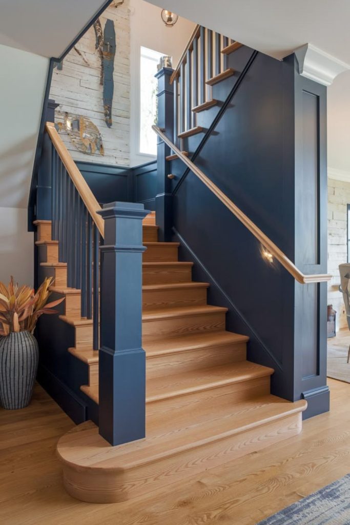 Navy staircase with elegant brass hardware.