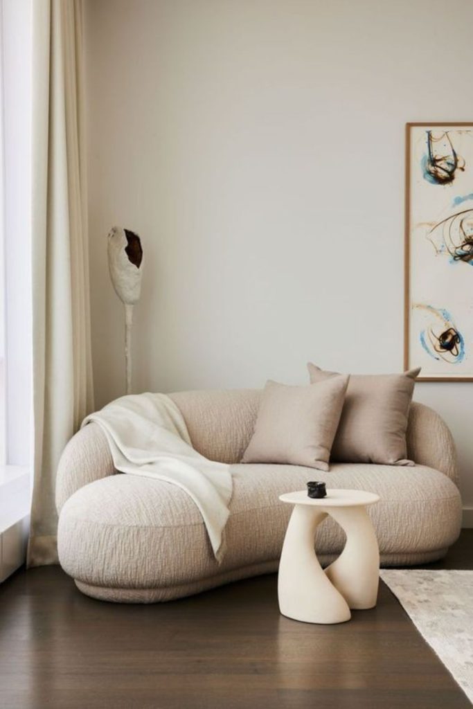 Compact curved loveseat for small rooms.