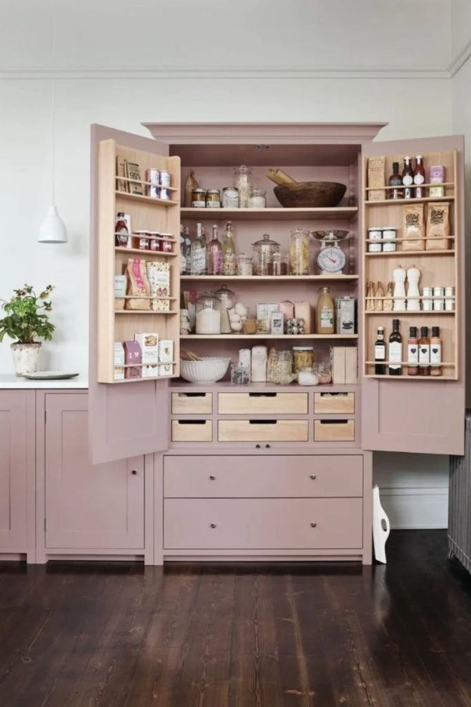 Soft pink larder with elegant shelving.