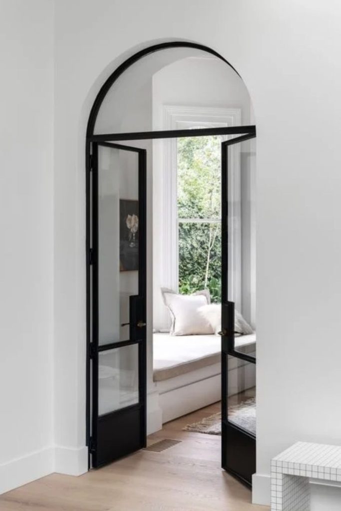 Black-framed glass archway with modern style.