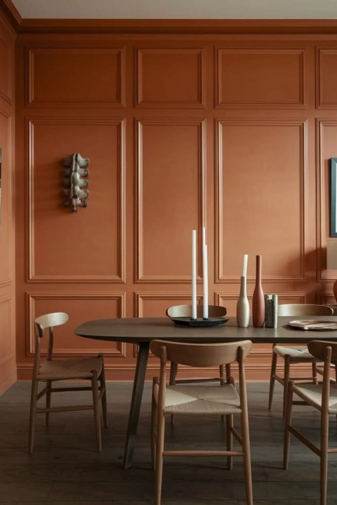 Burnt orange warm colour drenched dining room.