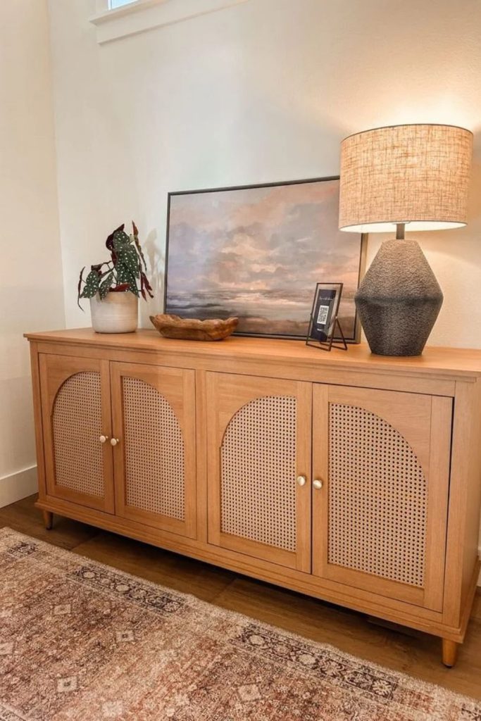 Cane console table with natural wooden accents