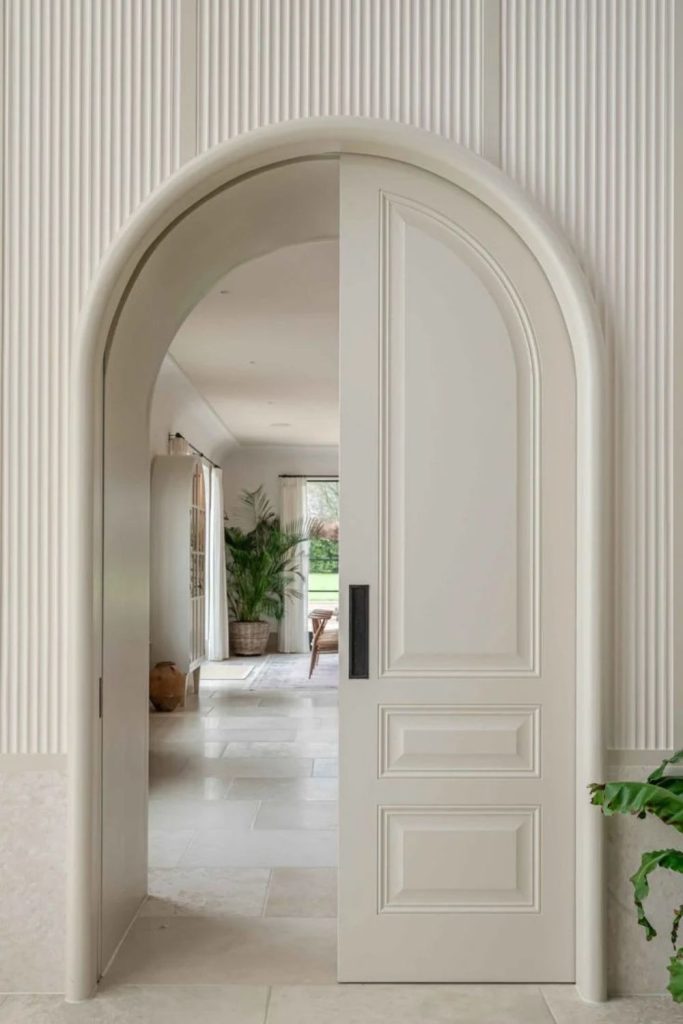 Cream plaster arch with subtle elegance.