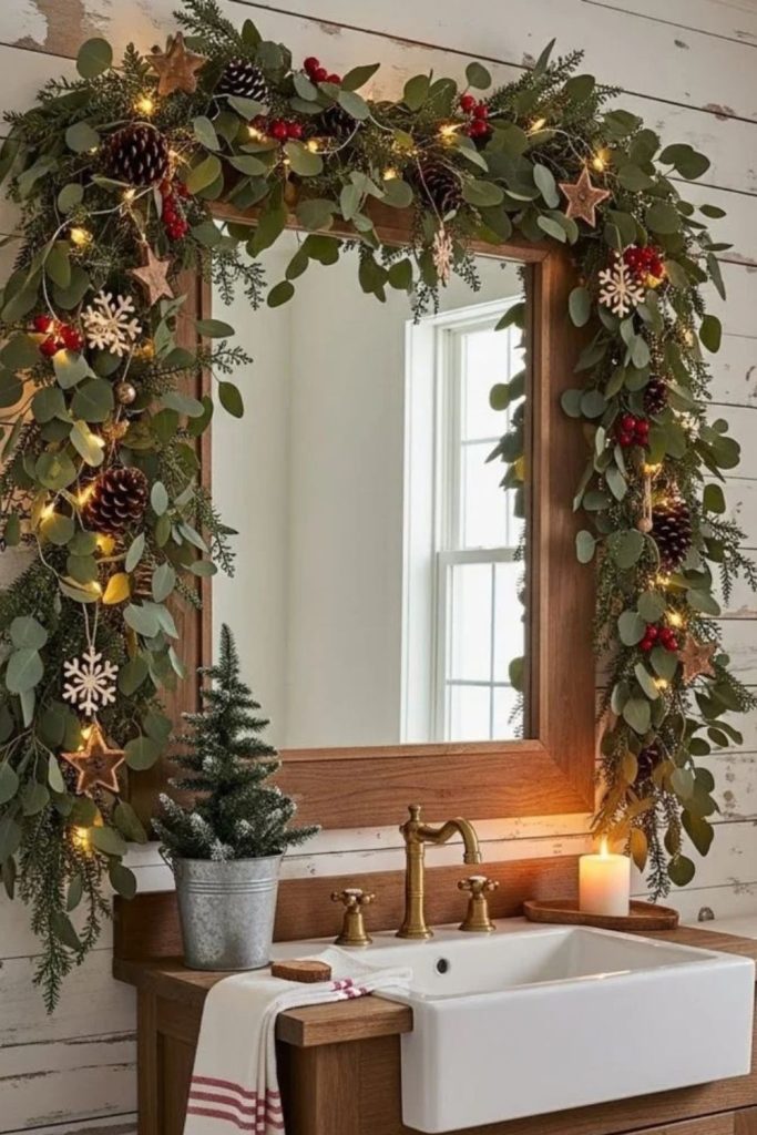 Evergreen garland framing a beautifully decorated bathroom mirror.