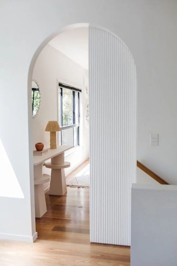 Fluted archway with sophisticated vertical texture.