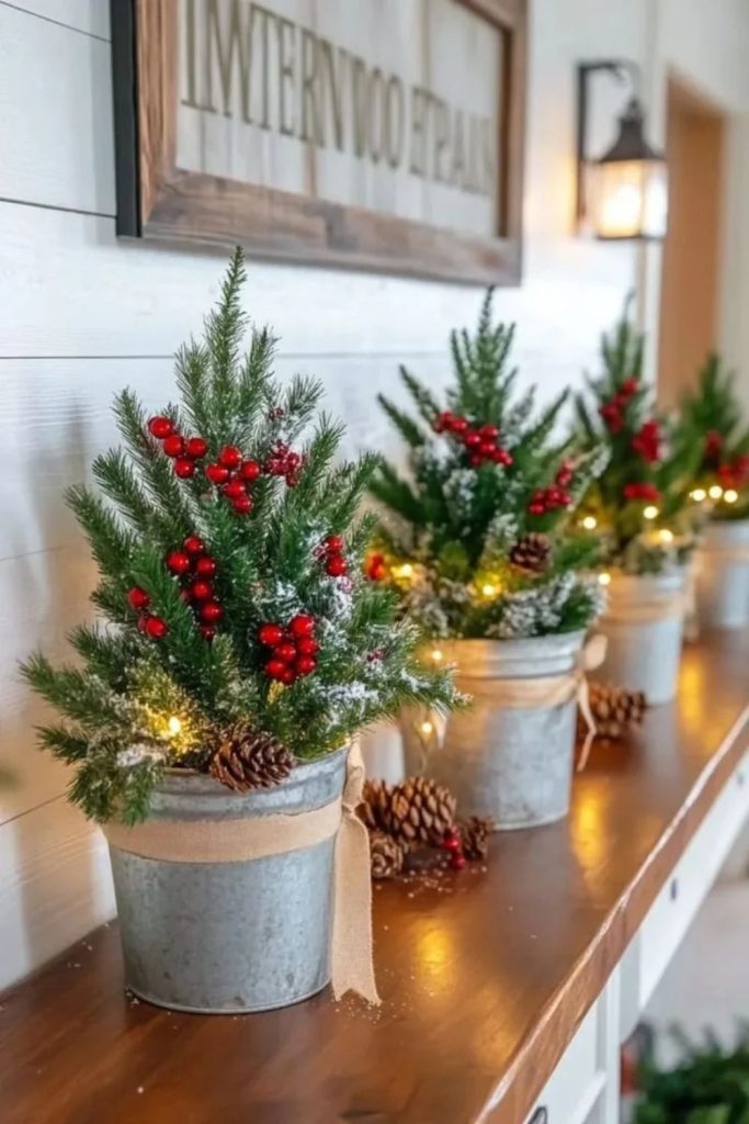 Galvanized buckets holding miniature Christmas trees.