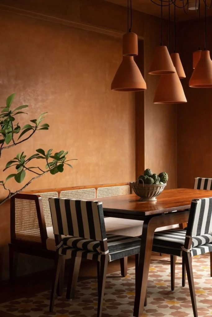 Modern terracotta dining room with wooden furniture