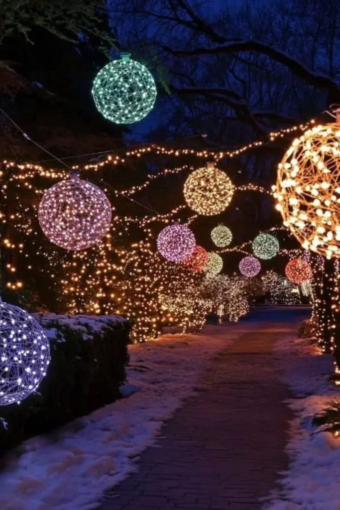 Oversized glowing Christmas ornaments decorating front yards.