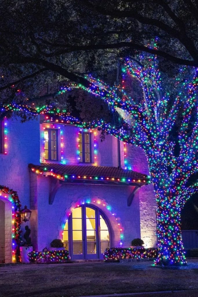 Rainbow Christmas lights illuminating colorful outdoor displays.
