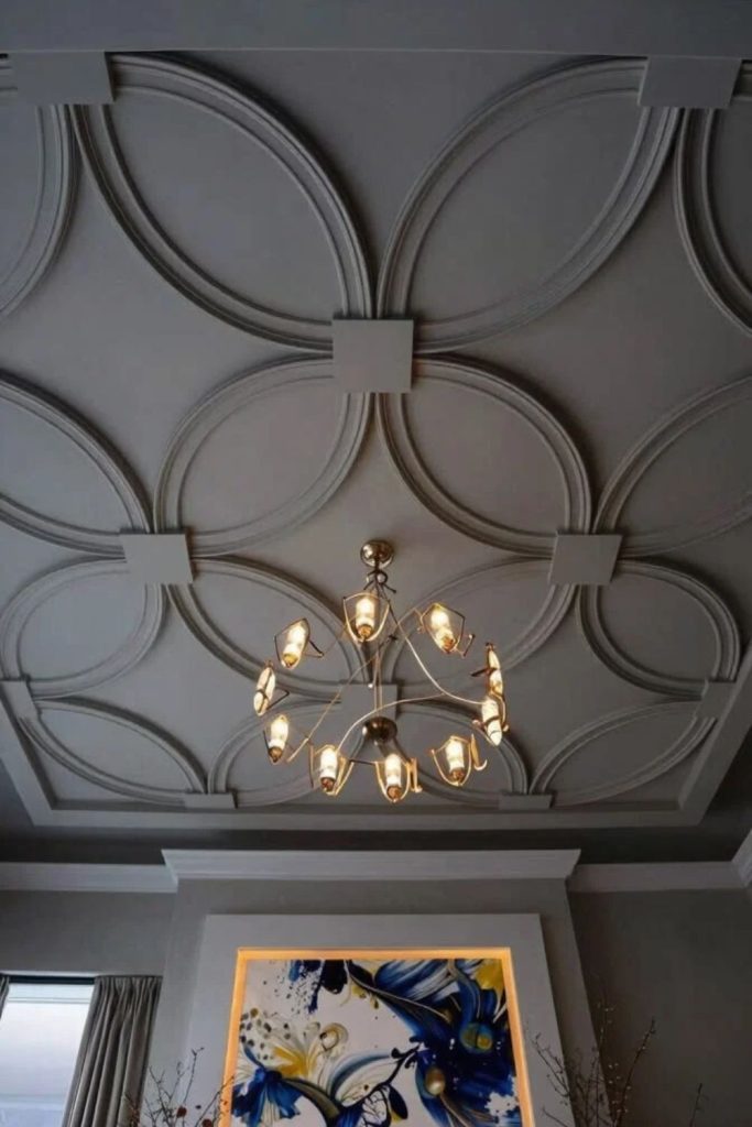Sculpted ceiling medallion with chandelier.