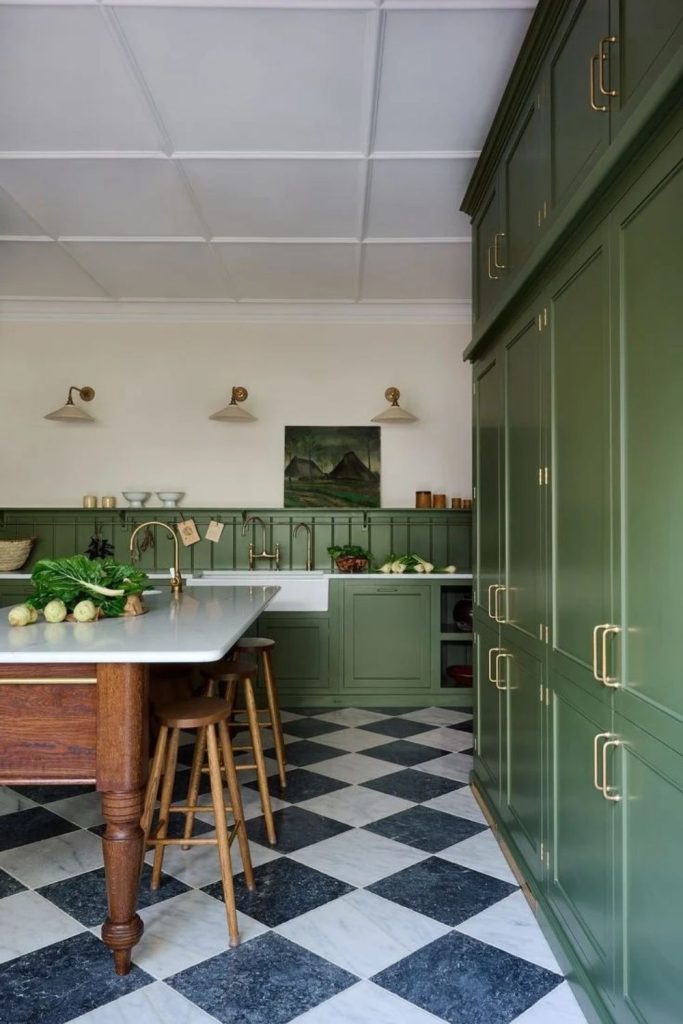 Olive green kitchen with vintage checkerboard flooring.