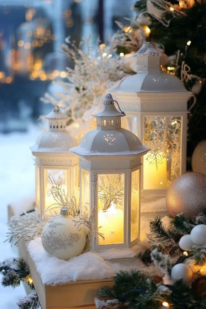 White Christmas lanterns with glowing candles and greenery.