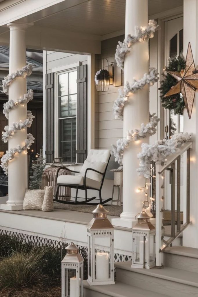 White Christmas porch with snowy trees and lanterns.